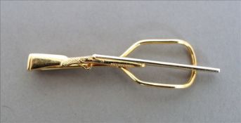 A 14 ct gold gentleman`s tie clip Formed as a shotgun. 5.5 cms wide. Overall good, slightly