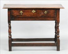 An 18th century elm topped side table The moulded rectangular planked top above a single frieze