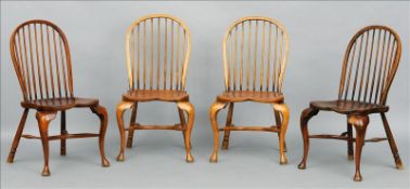 A set of four 18th century style beech and elm stick back Windsor chairs Each hooped back