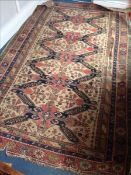 A 19th century Caucasian wool carpet The ivory field enclosing stylised cruciforms, rosettes and