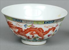 A Chinese porcelain bowl The exterior polychrome decorated with a phoenix and a five clawed dragon