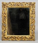 A 19th century carved giltwood framed mirror The deep frame carved with shells and scrolling