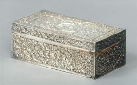 A 19th century Chinese silver box With allover cast floral decoration, the hinged rectangular top