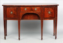 A George III mahogany sideboard The herringbone strung bowed top above a central frieze drawer