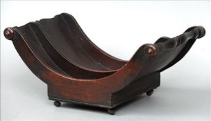 A 19th century mahogany cheese coaster Of typical form, with twin divisions, standing on castors. 45