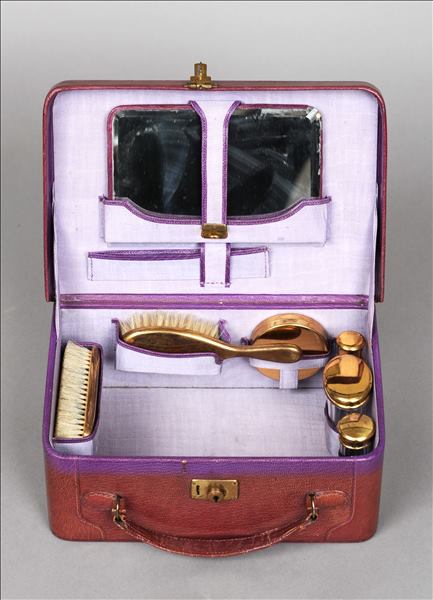 An early 20th century lady`s leather travelling vanity case The hinged rectangular lid enclosing the