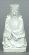 An 18th century blanc de chine porcelain figure Modelled as a seated dignitary. 15.75 cms high.