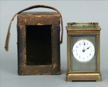 A Victorian brass cased repeating carriage clock The white enamel dial with Arabic numerals, with