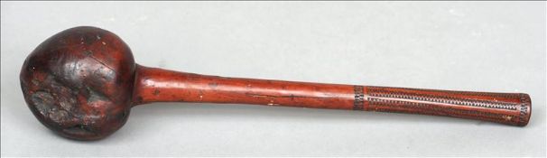 A Fijian carved hardwood throwing club The bulbous finial above the plain shaft with a chip carved
