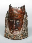 A 19th century carved beechwood tobacco pot The front carved as an Indian wearing a feathered