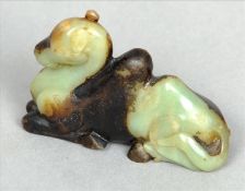 A Chinese carved green and black jade group Modelled as a recumbent camel. 8 cms long. Generally