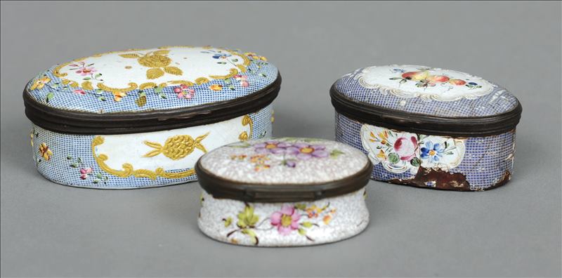 An 18th century enamelled snuff box Of oval form, decorated with fruit and flowers; together with