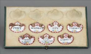 A part cased set of 19th century enamelled decanter labels Each decorated with floral sprays and