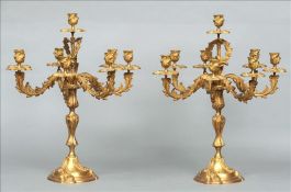 A pair of gilt bronze rococo style candelabra Each of floral scroll cast form, standing on a