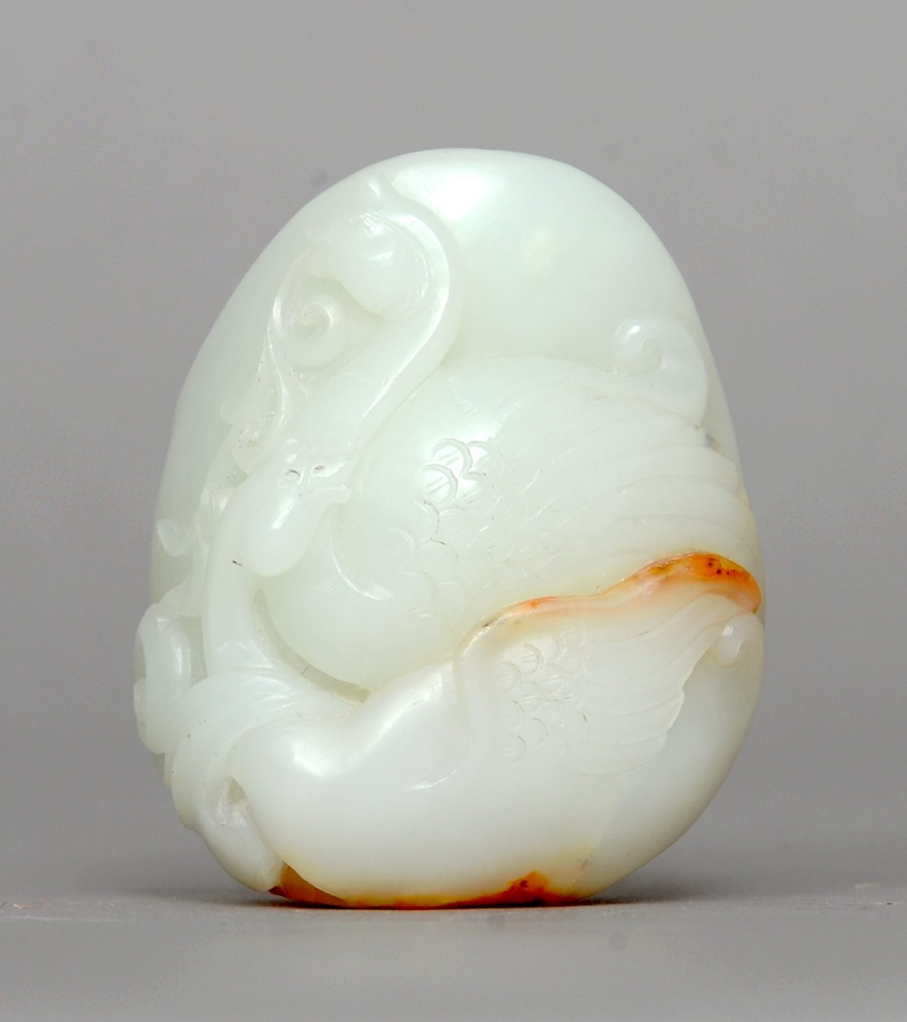 A Chinese white and russet jade pebble Carved with a pair of swans. 6 cms high. Generally in good