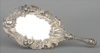 A 19th century Continental silver hand mirror, marks indistinct The ornate frame cast with cherubs