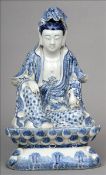 A Chinese porcelain blue and white figure of Guanyin Modelled in traditional pose holding a gourd
