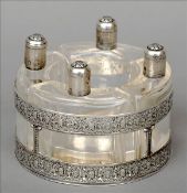 An early 20th century French silver mounted perfume bottle set Comprising: four curved clear glass