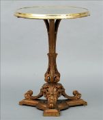 A Victorian brass and cast iron display table The mirrored top enclosed with a brass ring,