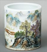 A Chinese porcelain brush pot Of circular section, decorated with a continuous landscape and