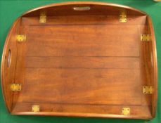 A late 19th/early 20th century mahogany butler`s tray The panelled tray with brass hinged folding