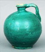 A green glazed pottery ewer, possibly 18th century Iberian 26 cms high. Generally in good condition,