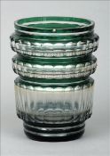 A green cased cut glass vase Of circular section with fluted decoration. 21.5 cms high. Generally in