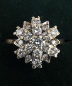A 9 ct gold diamond set flowerhead ring The round brilliant cut stones claw set. Generally in good