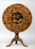 A chinoiserie lacquered tilt top tripod table The circular top decorated with various scenic