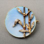 A Continental gold and diamond brooch Set as bamboo stems, on an enamelled background, the reverse