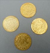 Four Indian gold coins Each decorated to one side with a ruler, the other with script. 2 cms