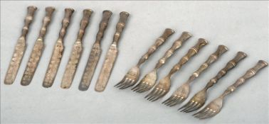 A set of six Chinese silver table knives and forks, marked 90, maker`s mark of Wang Hing The handles
