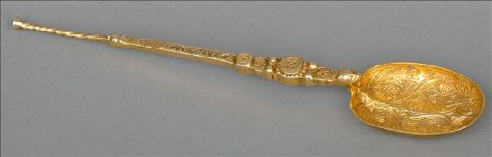 An early 20th century silver gilt anointing spoon, hallmarked Birmingham 1936, maker`s mark of CFT