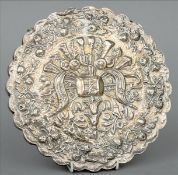 A Continental silver mounted mirror Embossed overall with musical trophies within a scrolling floral