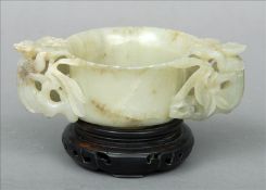 A Chinese carved jade twin handled drinking vessel The handles pierced and foliate carved,