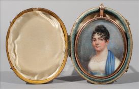 An early 19th century yellow metal framed portrait miniature Depicting a young lady with blue