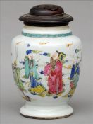 A Chinese porcelain vase Decorated with figures in a continuous landscape, with pieced wooden cover.