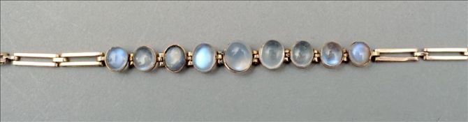 A 9 ct gold moonstone bracelet Centrally set with nine cabochon moonstones. 15.5 cms long. Two