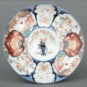 A large 19th century Imari charger Decorated with vignettes of various birds, figures and objects