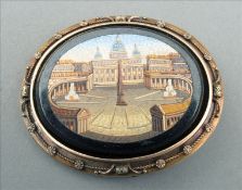 A 19th century unmarked gold framed micro-mosaic brooch The rope twist cast gold frame enclosing a