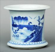 A Chinese blue and white porcelain brush pot Of circular section with flared rim and foot, decorated