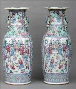 A pair of 19th century Cantonese enamel decorated vases The flared neck rim above twin scholarly