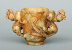 A Chinese carved jade twin handled drinking vessel The top rim with incised Greek key decoration,