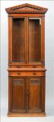 A Victorian walnut bookcase cabinet The arched dentil moulded cornice above twin bevelled glazed