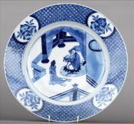 An 18th century Chinese blue and white plate The main body decorated with kneeling figures in an