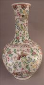A 19th century enamel decorated Chinese vase. The flared neck rim above the bulbous body decorated