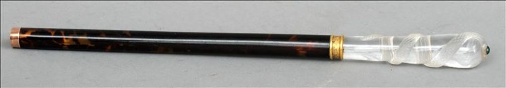 A tortoiseshell and rock crystal cane/parasol handle The top carved with an entwined snake, its head