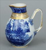 An 18th century Chinese blue and white sparrow beak jug The top rim and neck with gilt detailing,