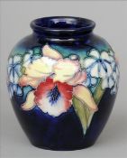 A Moorcroft Orchid and Spring Flowers pattern vase Of squat bulbous form, the base signed and with