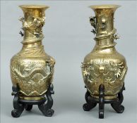 A pair of 19th century Chinese bronze vases Each decorated with entwined dragons chasing flaming